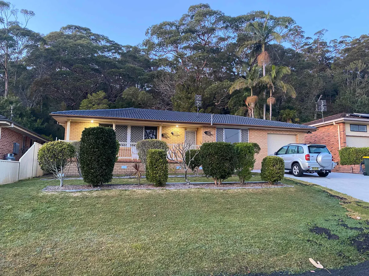 A single-storey brick home with a freshly restored charcoal tiled roof in Nowra