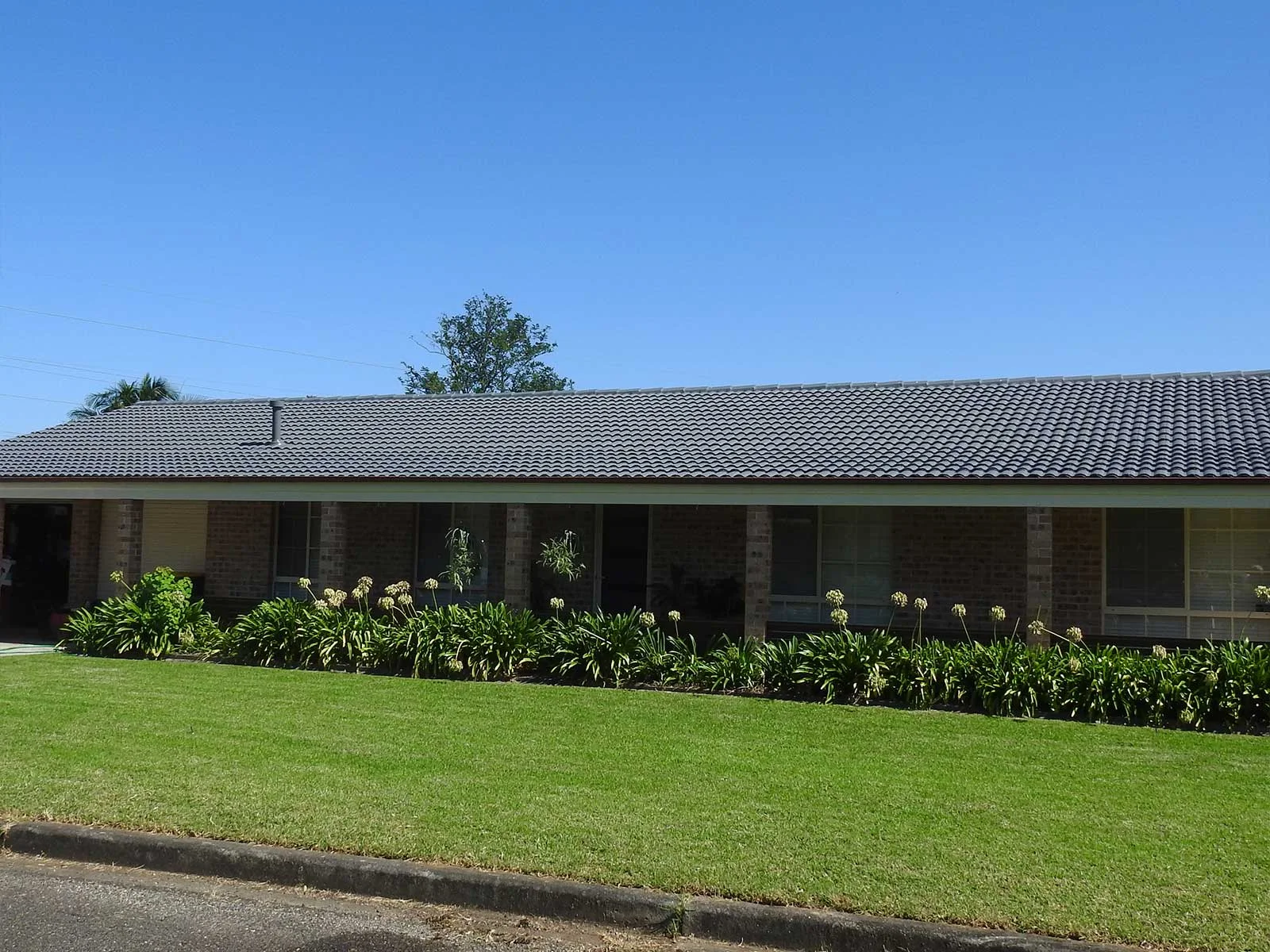 A long roof line restored across a South Coast home